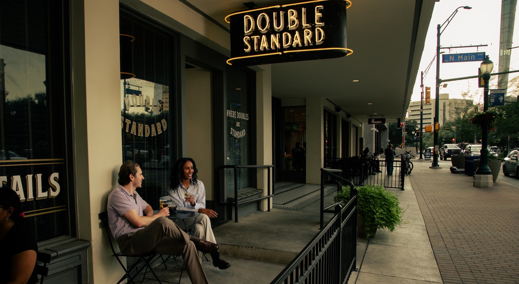 a couple sitting downtown beside a coffee shop